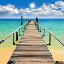 Fotobehang - Beach, sun, bridge
